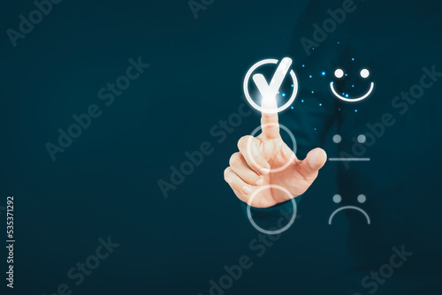 Man touching the virtual screen on the happy smiley face icon to give satisfaction in service. Rating very impressed. Customer service, testimonial satisfaction concept.