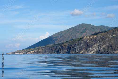 A glimpse of Atauro Island in Timor-Leste, South East Asia, on extinct Wetar segment of the volcanic Inner Banda Arc, rugged, rocky, steep ridges and slopes of remote island in the tropics