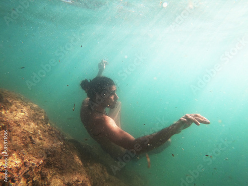 Young male underwater in the sea.