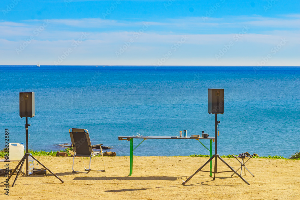 Camp chairs, table and music equipment on beach Camp chairs, table and music equipment on beach