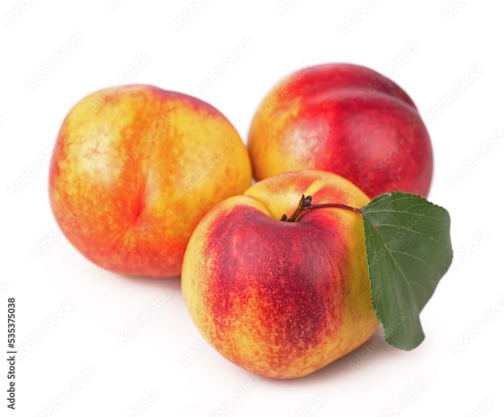 fresh nectarines with leaves isolated on white background fresh nectarines with leaves isolated on white background