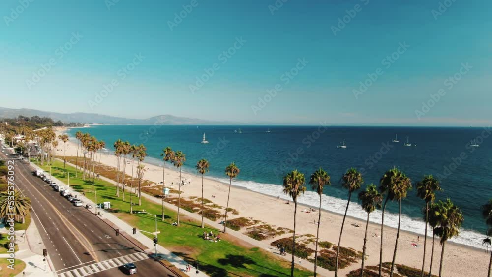Aerial Drone view on beach coastline in Los Angeles, California, USA. Beautiful sunny day during summer. Palms and grass. People and cars on streets near ocean. High quality 4k footage Aerial Drone view on beach coastline in Los Angeles, California, USA. Beautiful sunny day during summer. Palms and grass. People and cars on streets near ocean. High quality 4k footage