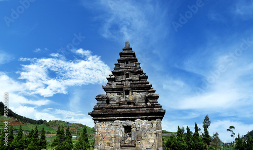 Arjuno Temple with a bright blue sky in the background in the Dieng plateau, Wonosobo, Central Java, Indonesia photo