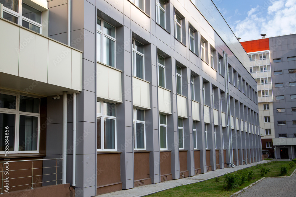 Facade of a modern building with rows of windows.