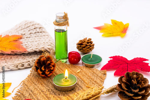 herbal oils, candle aromatherapy for health care with maple leaf in autumn season arrangement flat lay style on background white 