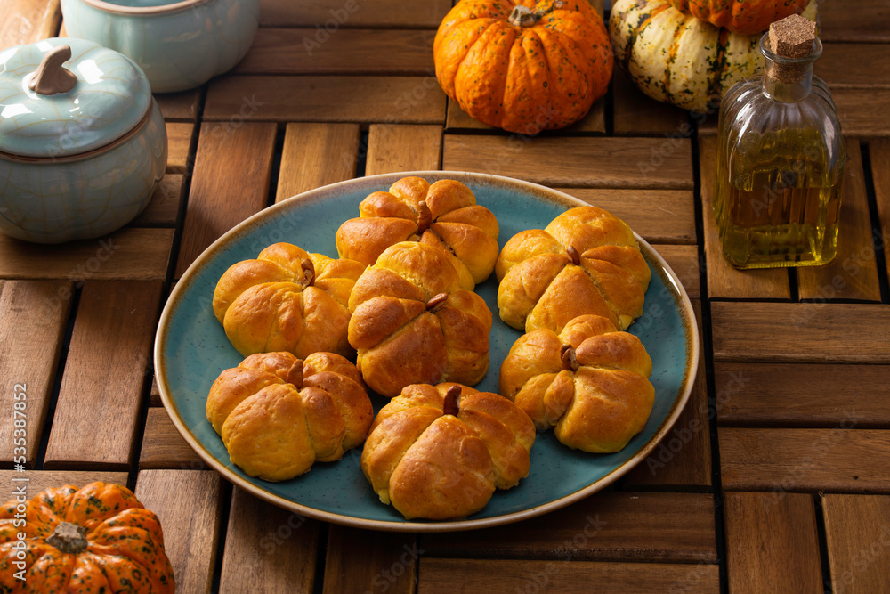 Pumpkin buns on a wooden table Pumpkin buns on a wooden table