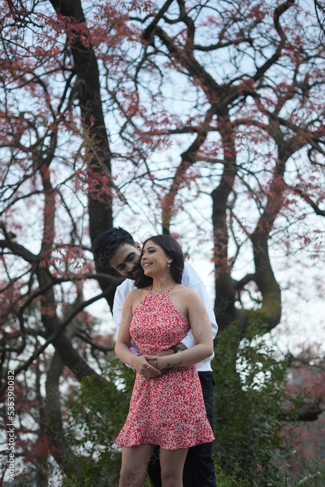 couple doing fun in a park couple doing fun in a park