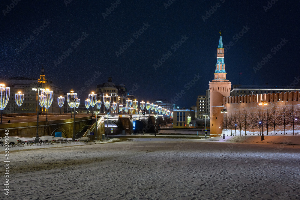 Fototapeta premium Spasskaya tower and winter Kremlin against the backdrop of street Christmas decorations.