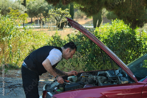 Mechanic fixing car engine photo