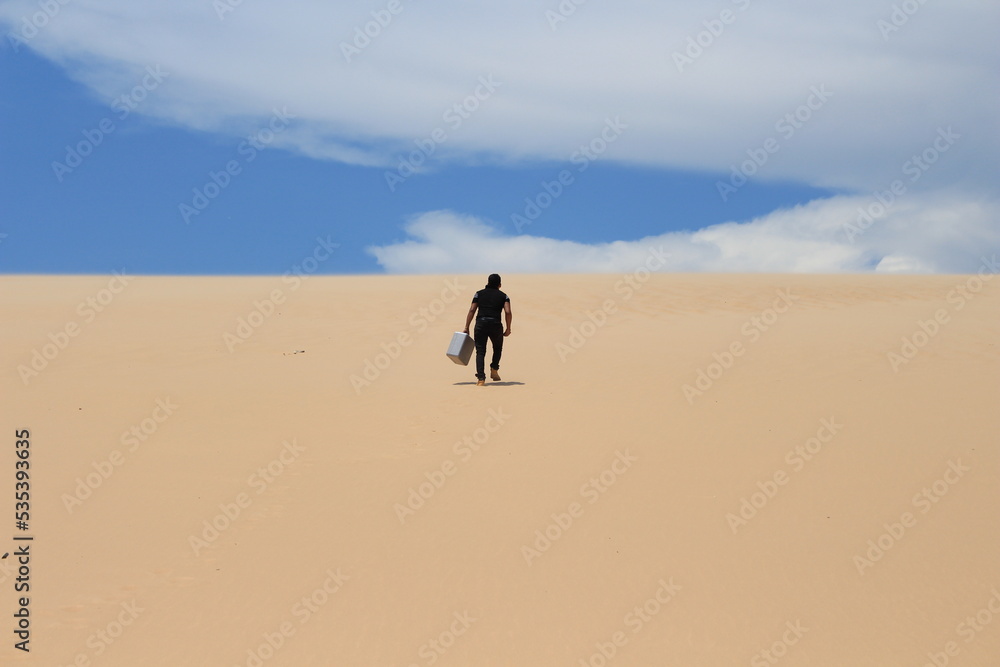 Young man walking on the sand and looking for a sign - LOMAS DE ARENA SANTA CRUZ BOLIVIA Young man walking on the sand and looking for a sign - LOMAS DE ARENA SANTA CRUZ BOLIVIA