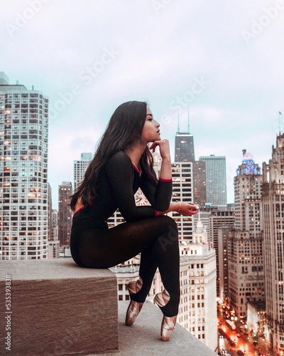 Profile of ballerina sitting on top of building in Chicago, USA photo