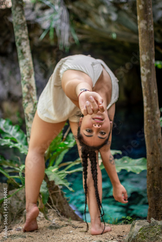 Woman back bending in forest