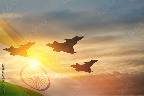 Indian Air Force Day. Indian jet air shows on background of sunset with transparent Indian flag. Commemorate Indian Air Force Day on October 8 in India. photo