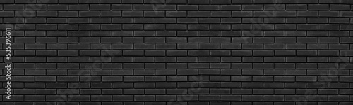 Old black brick wall wide texture. Dark shabby brickwork grunge panoramic background