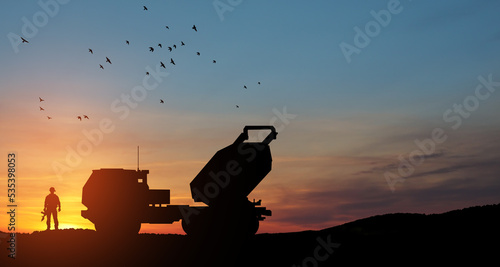 Artillery rocket system are aimed to the sky and soldier at sunset. Multiple launch rocket system. 3d-rendering. photo
