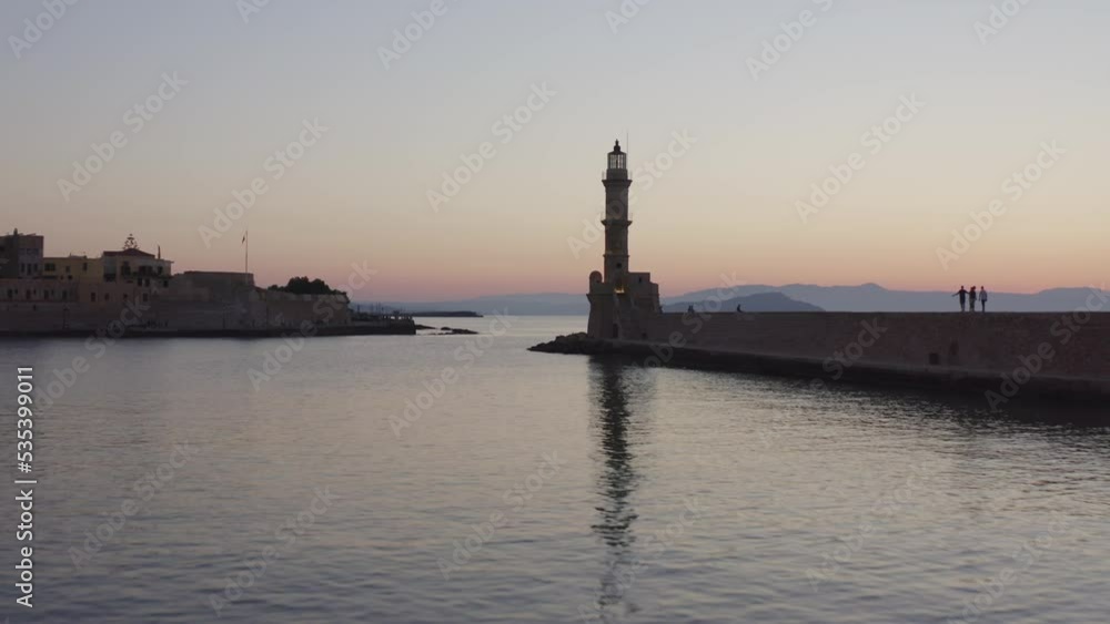 Aerial - Flying from low to high in Chania, Greece old port, passing by the lighthouse Aerial - Flying from low to high in Chania, Greece old port, passing by the lighthouse