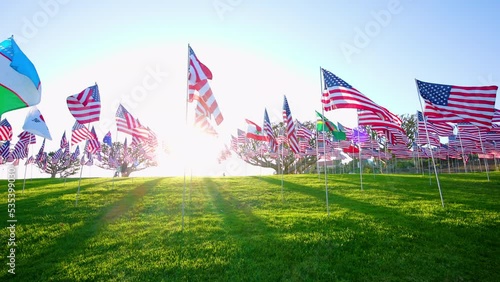 Iconic Waves of Flags annual ceremony at Pepperdine University, CA, USA. Shot of honoring the lives lost in the terror attacks on September 09,11, 2001. Backlight sunset. High quality 4k footage photo