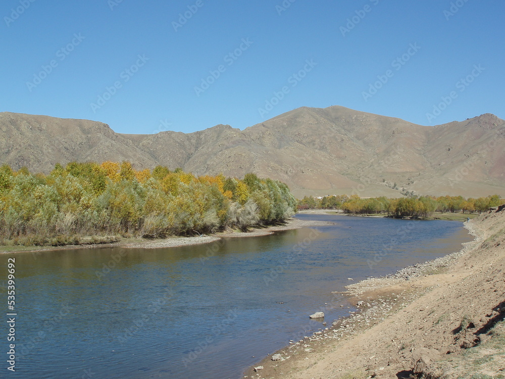 Along the cold river in the tranquility of the silent valley in Gajurt region, Tuv, Mongolia. The water is cold and clear. Some may fish around the river. The valley is quiet throughout the year. 