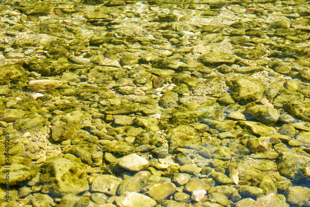 Small pebbles under the water in the river. Abstract nature backgrounds Small pebbles under the water in the river. Abstract nature backgrounds