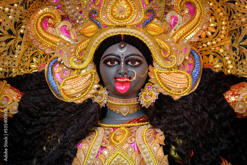 Idol of Goddess Maa Kali at a decorated puja pandal in Kolkata, West Bengal, India. Kali puja also known as Shyama Puja is a famous religious festival of Hinduism. photo