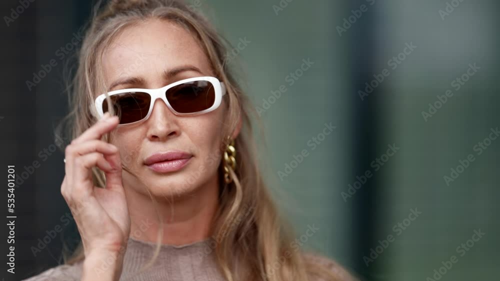 Portrait of successful rich woman with sunglasses, closeup of smiling face Portrait of successful rich woman with sunglasses, closeup of smiling face