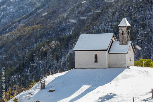Chapel on a hill with snow in the air