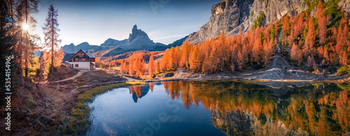 Panoramic autumn view of popular tourist destination - Federa lake. Picturesque sunrise in Dolomite Alps. Amazing morning scene of Italy, Europe. Beauty of nature concept background..