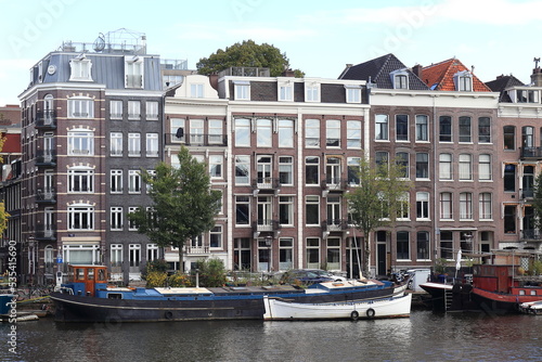 Amsterdam Amstel River View with Boats and House Facades, Netherlands