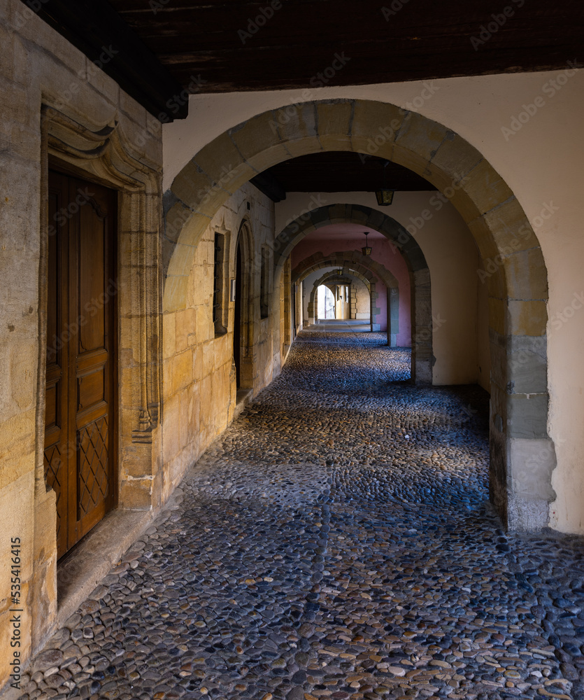 Obraz premium Medieval passage with stone arches in Estavayer le lac, Switzerland