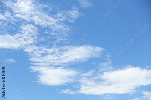 Group of white fluffy clouds and bright blue sky in day time.