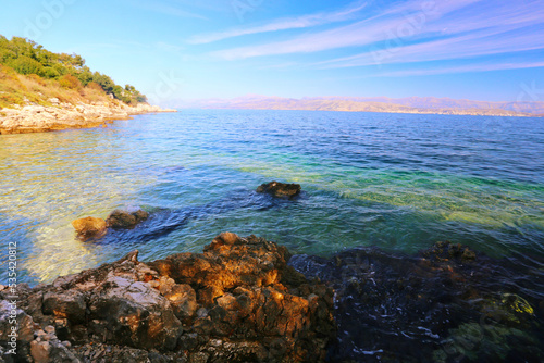 beach in Kassiopi resort, nort coast of Corfu (Kerkyra) island, Greece, albanian coast on horyzon. ..exclusive - this image sell only on Adobestock 
