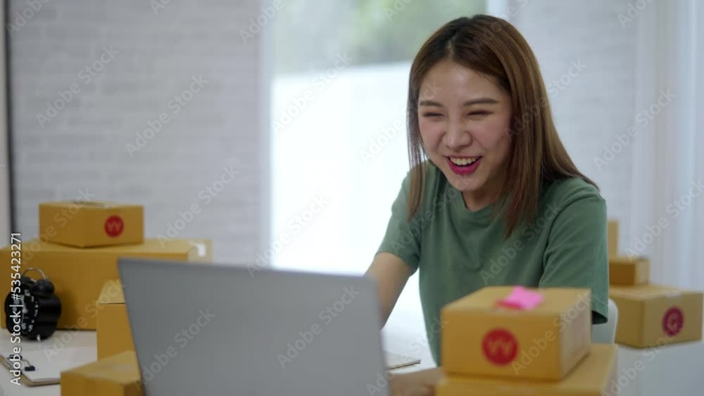 Young owner business woman received orders from clients and preparing products in parcel cardboard box packaging at home. Young owner business woman received orders from clients and preparing products in parcel cardboard box packaging at home.