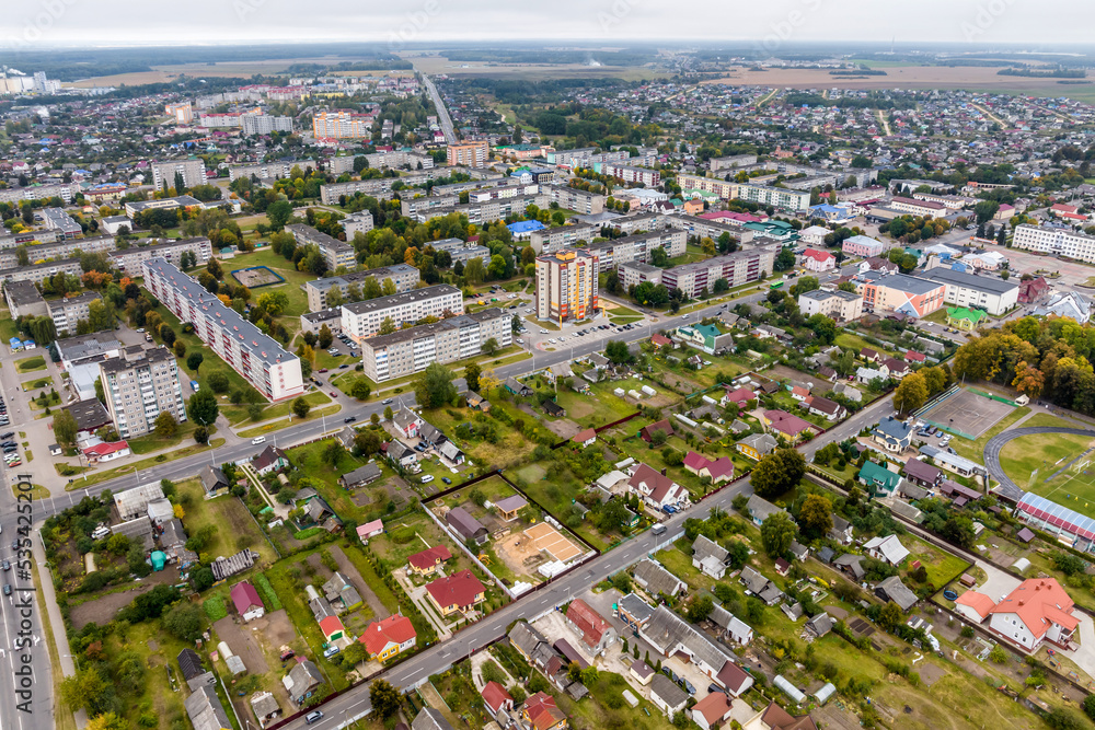 aerial panoramic view from a great height of a small provincial green town with a private sector and high-rise apartment buildings