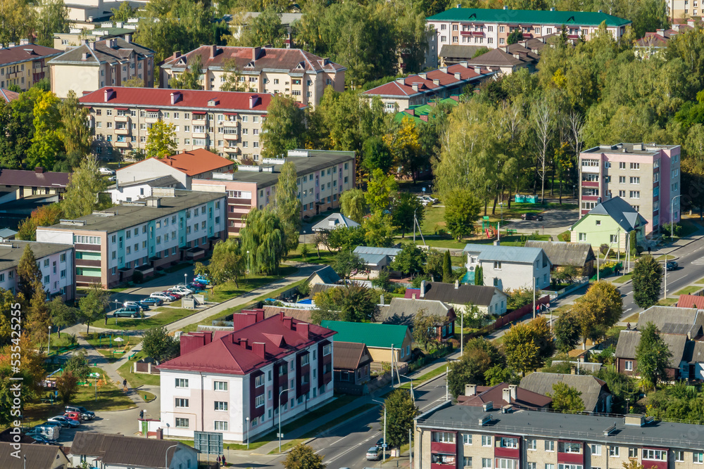 Fototapeta premium aerial panoramic view from a great height of a small provincial green town with a private sector and high-rise apartment buildings
