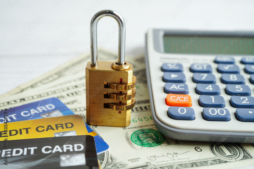 Credit card with password key lock and US dollar banknote money, security finance business concept.