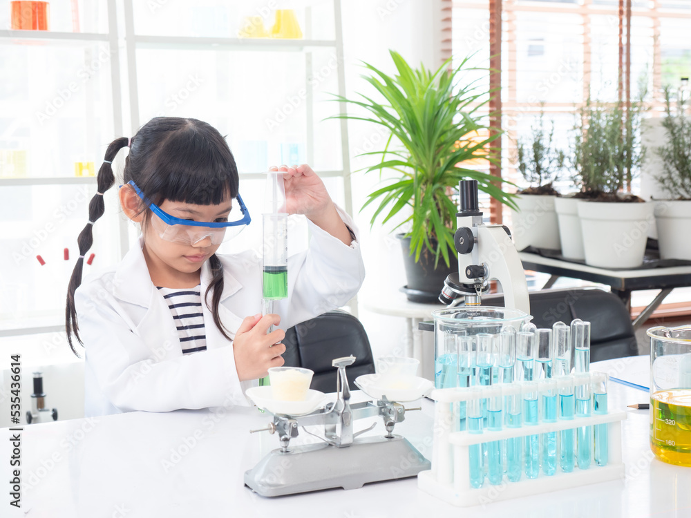 Little asian cute girl 6 years old learning in science lab with equipment and looking at liquid chemicals in tube. Learning and education of kid. Little asian cute girl 6 years old learning in science lab with equipment and looking at liquid chemicals in tube. Learning and education of kid.