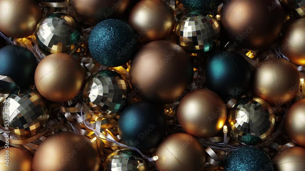 christmas and new year background - close up of golden and green Christmas baubles with led lights christmas and new year background - close up of golden and green Christmas baubles with led lights