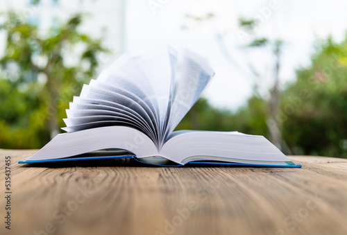 Open book on wooden table