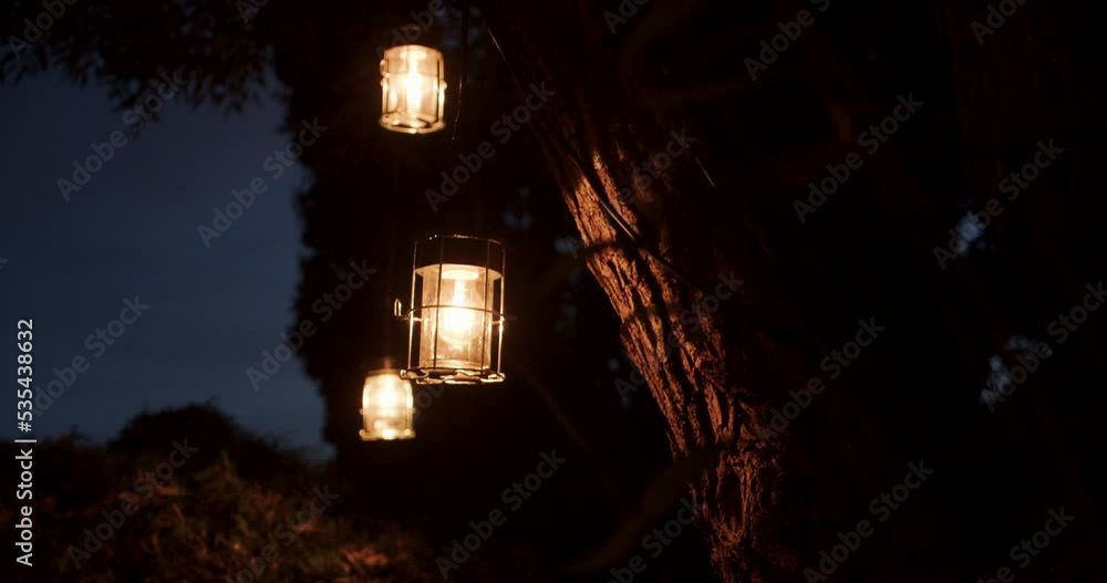 Slow dolly shot showing three lanterns hanging from a tree branch Slow dolly shot showing three lanterns hanging from a tree branch