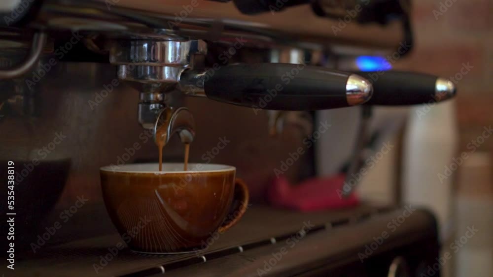 Close up of Professional machine pouring Coffee in a cup, Coffee shop concept Close up of Professional machine pouring Coffee in a cup, Coffee shop concept