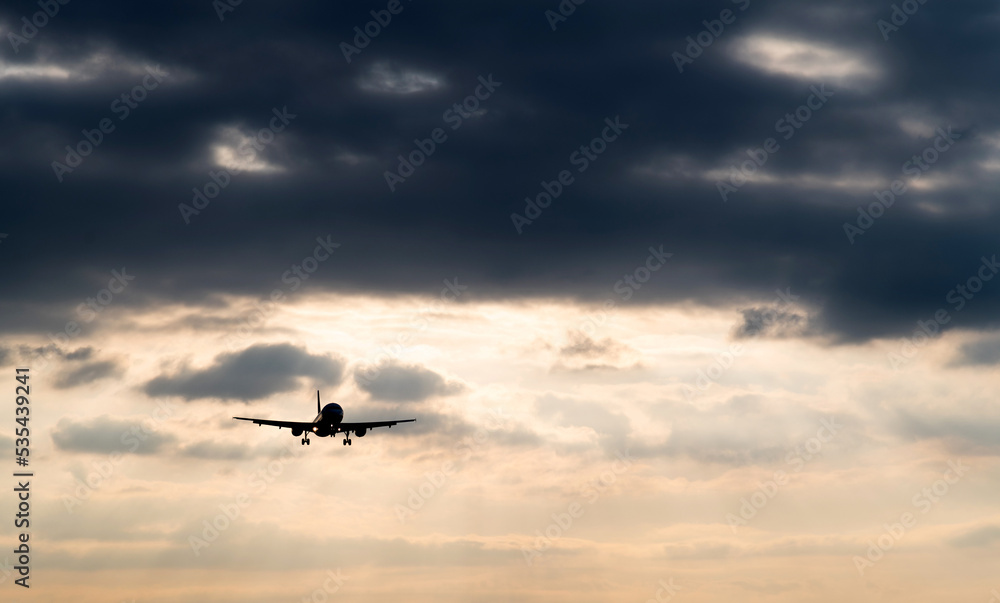 Airplane flying in overcast sky