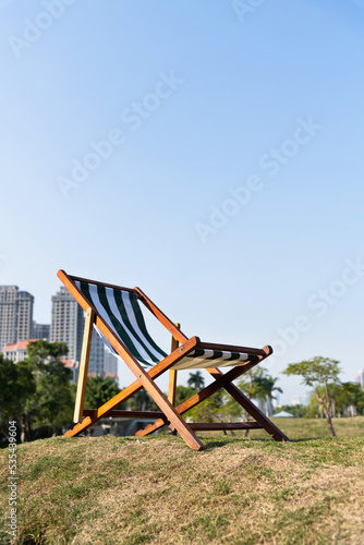 Deck chair on the meadow in the garden