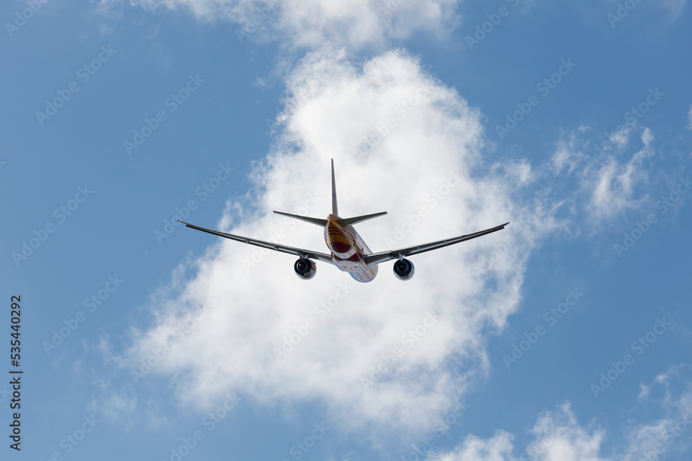 G-DHLY 777-F Climbing after takeoff from EMA with editorial space - stock photo.jpg