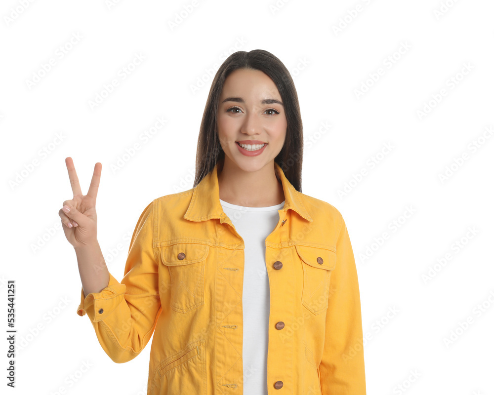 Woman in yellow jacket showing number two with her hand on white background Woman in yellow jacket showing number two with her hand on white background
