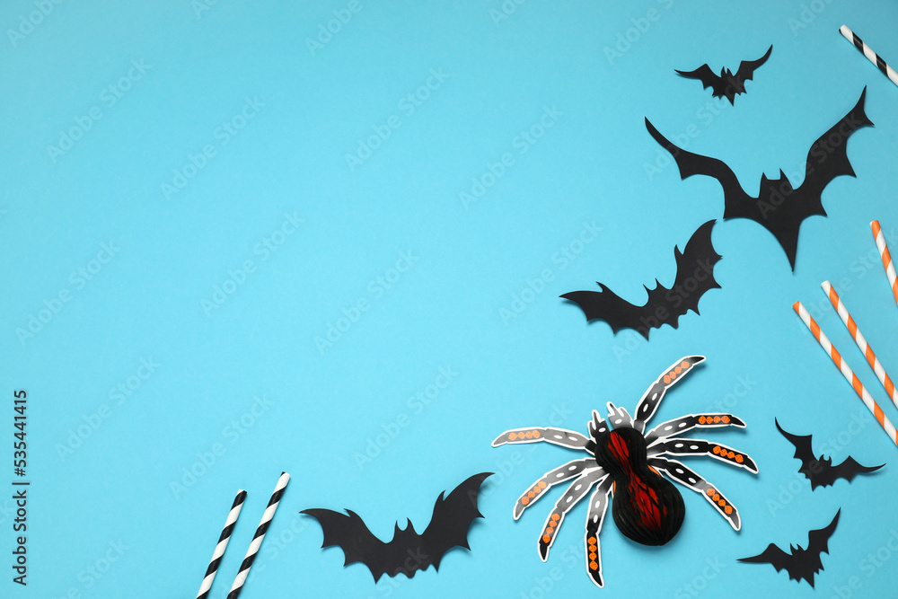 Flat lay composition with paper bats, spider and cocktail straws on light blue background, space for text. Halloween decor Flat lay composition with paper bats, spider and cocktail straws on light blue background, space for text. Halloween decor