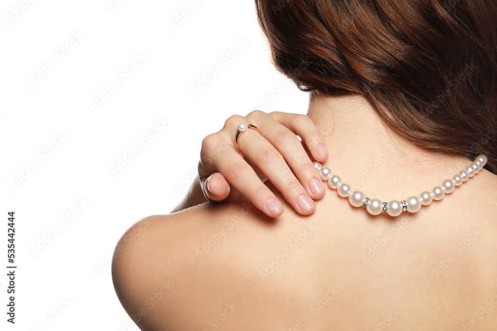 Young woman wearing elegant pearl jewelry on white background, back view