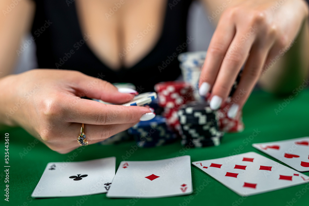girl in the poker game has won everything and takes all the chips with her hands. girl in the poker game has won everything and takes all the chips with her hands.