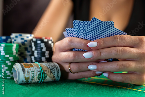 beautiful woman with poker cards is playing low in poker.