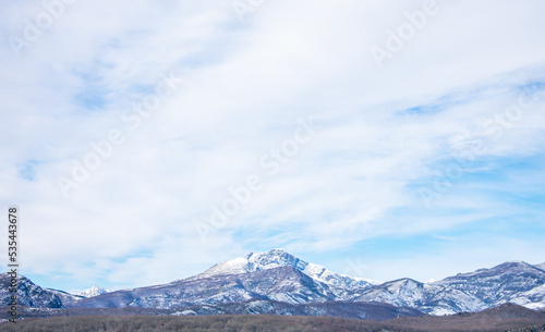 snow capped mountains with blue sky and clouds © photointruder