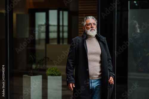 Portrait of a senior businessman outside of the office building